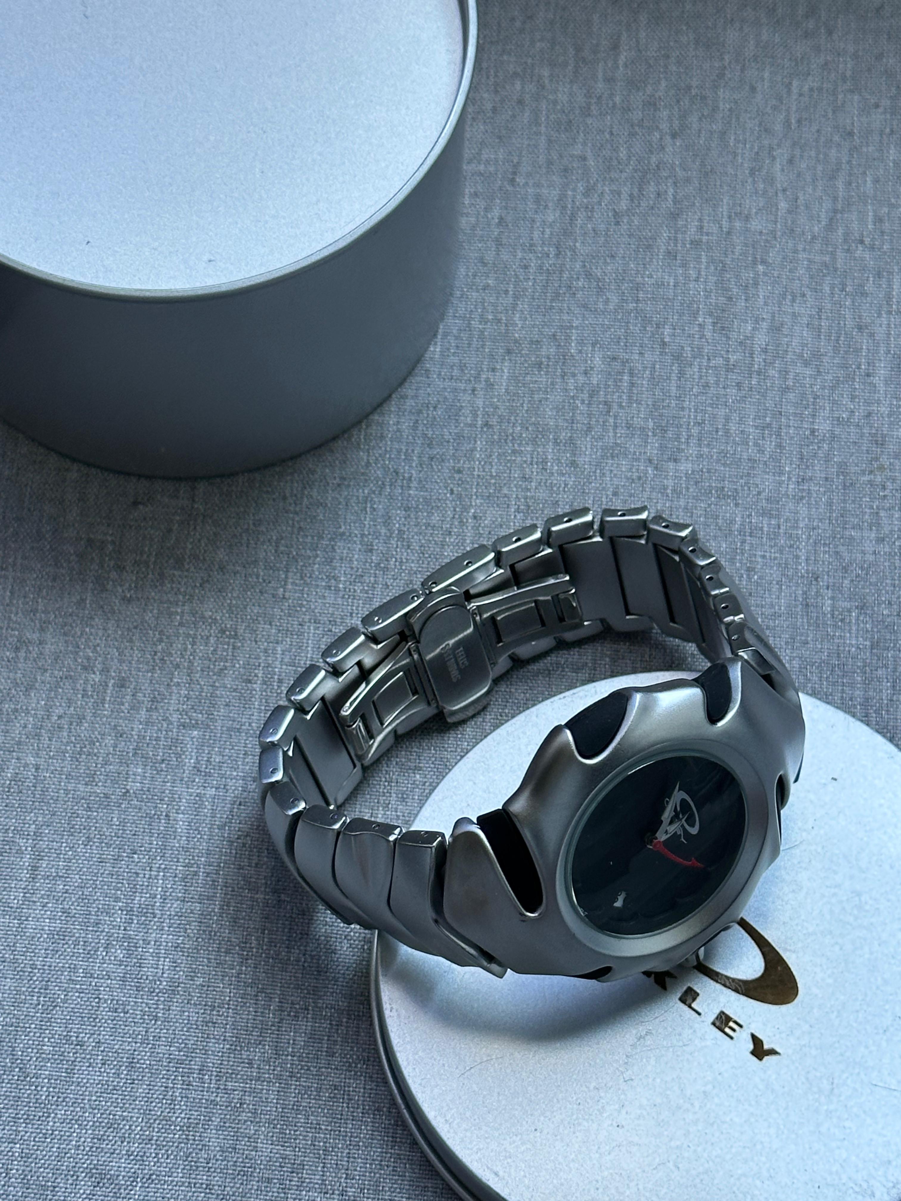 Oakley Time Tank Watch: Silver Stainless Steel with Black Dial, Swiss Movement