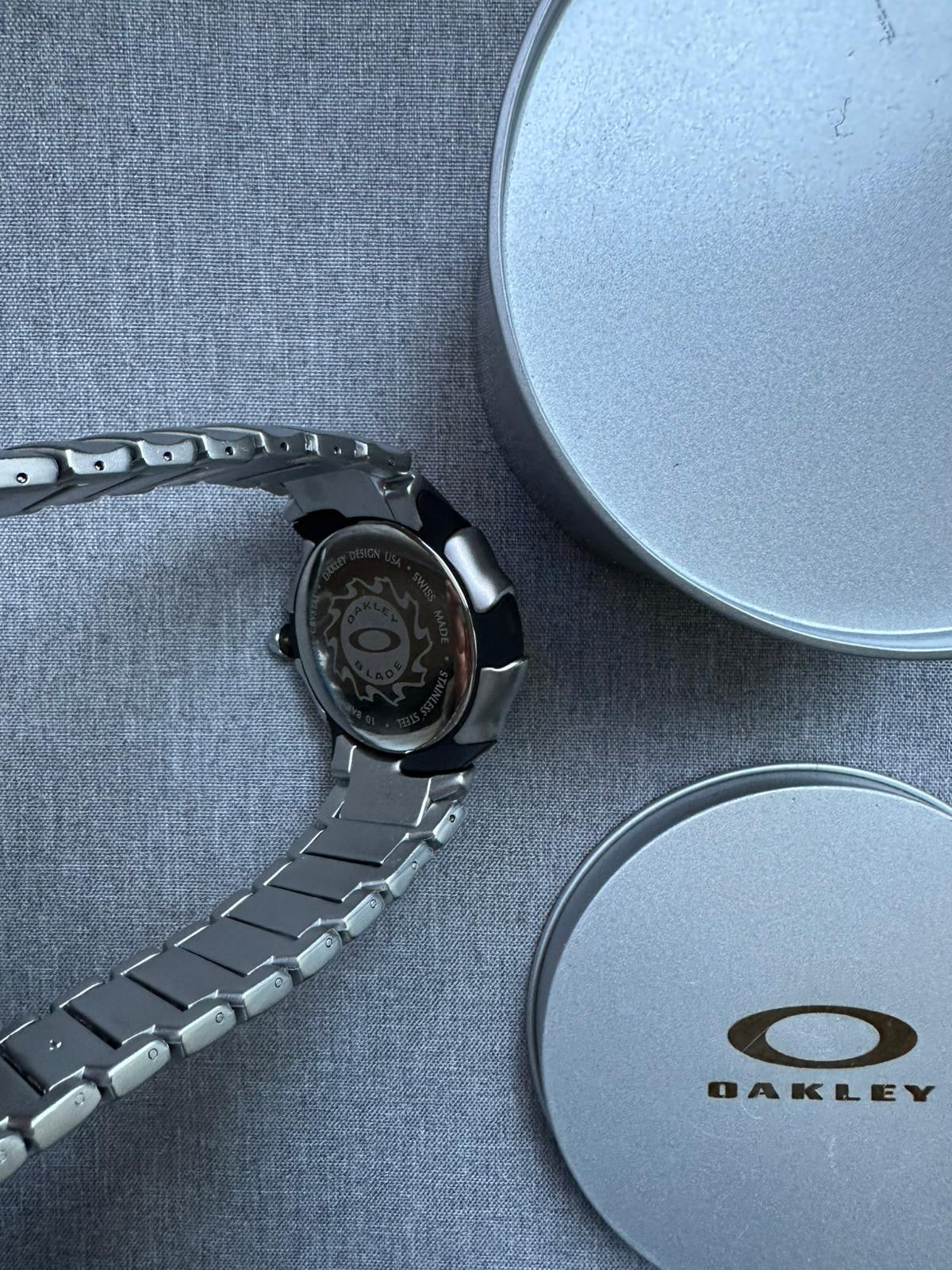 Oakley Time Tank Watch: Silver Stainless Steel with Black Dial, Swiss Movement