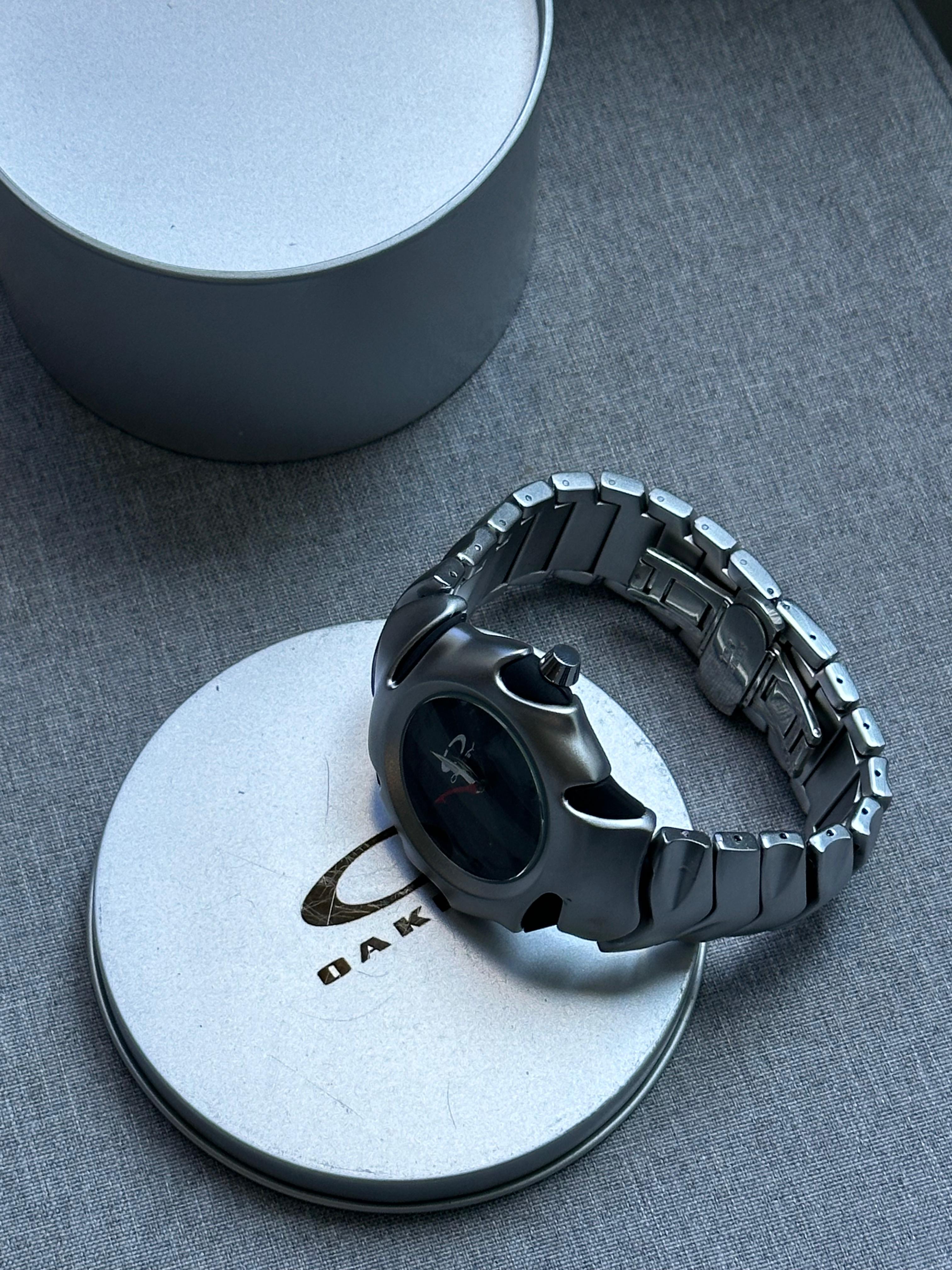 Oakley Time Tank Watch: Silver Stainless Steel with Black Dial, Swiss Movement