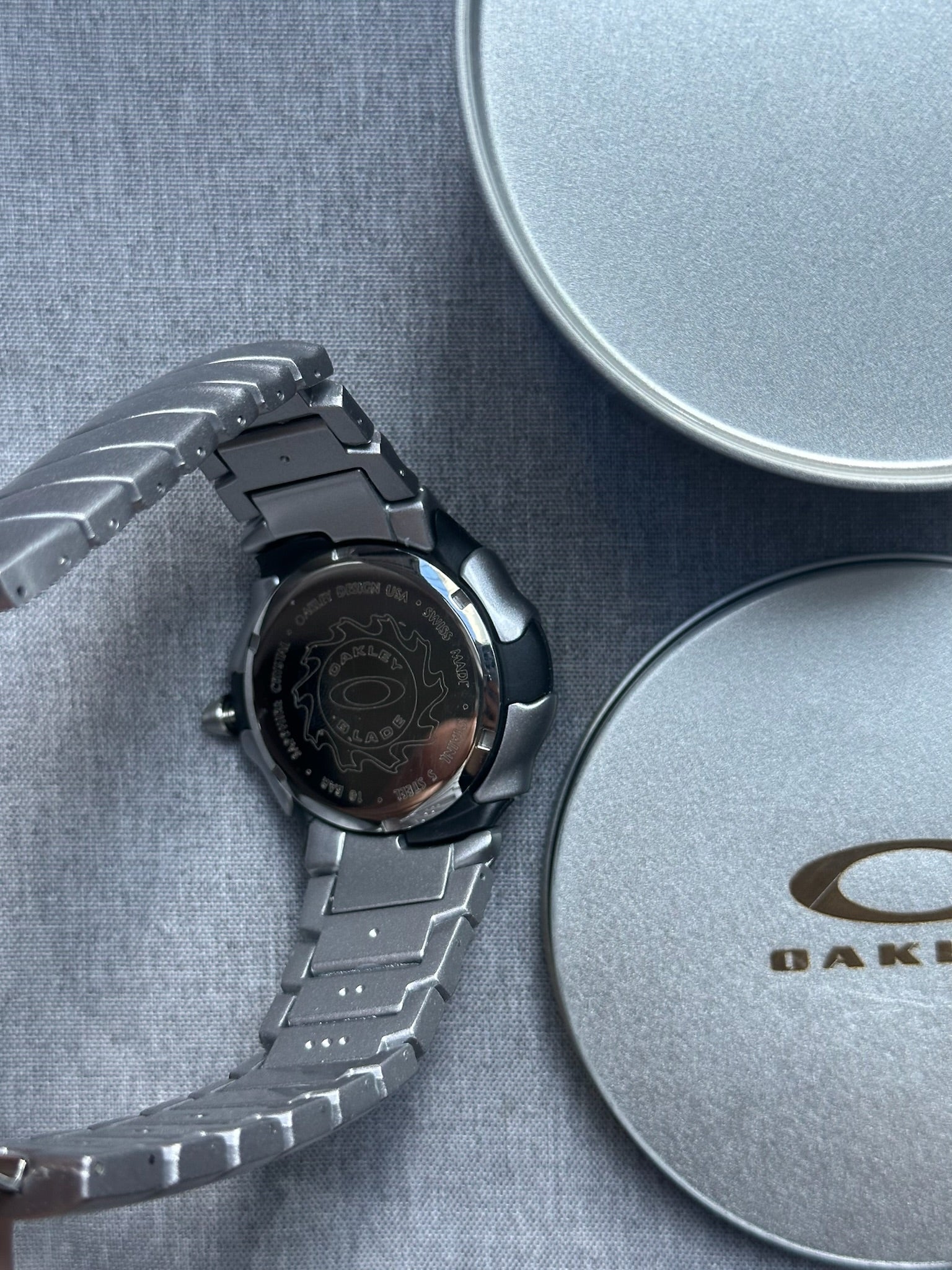 Oakley Blade Watch: Silver Brushed Stainless Steel with Red Dial, Swiss Movement